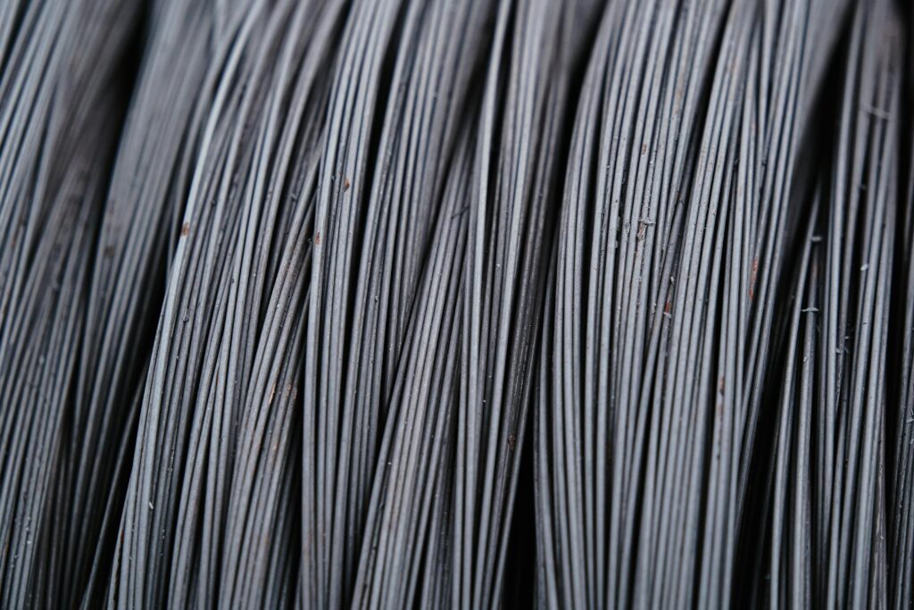 Detailed macro shot of intertwined metal wires, showcasing industrial texture.