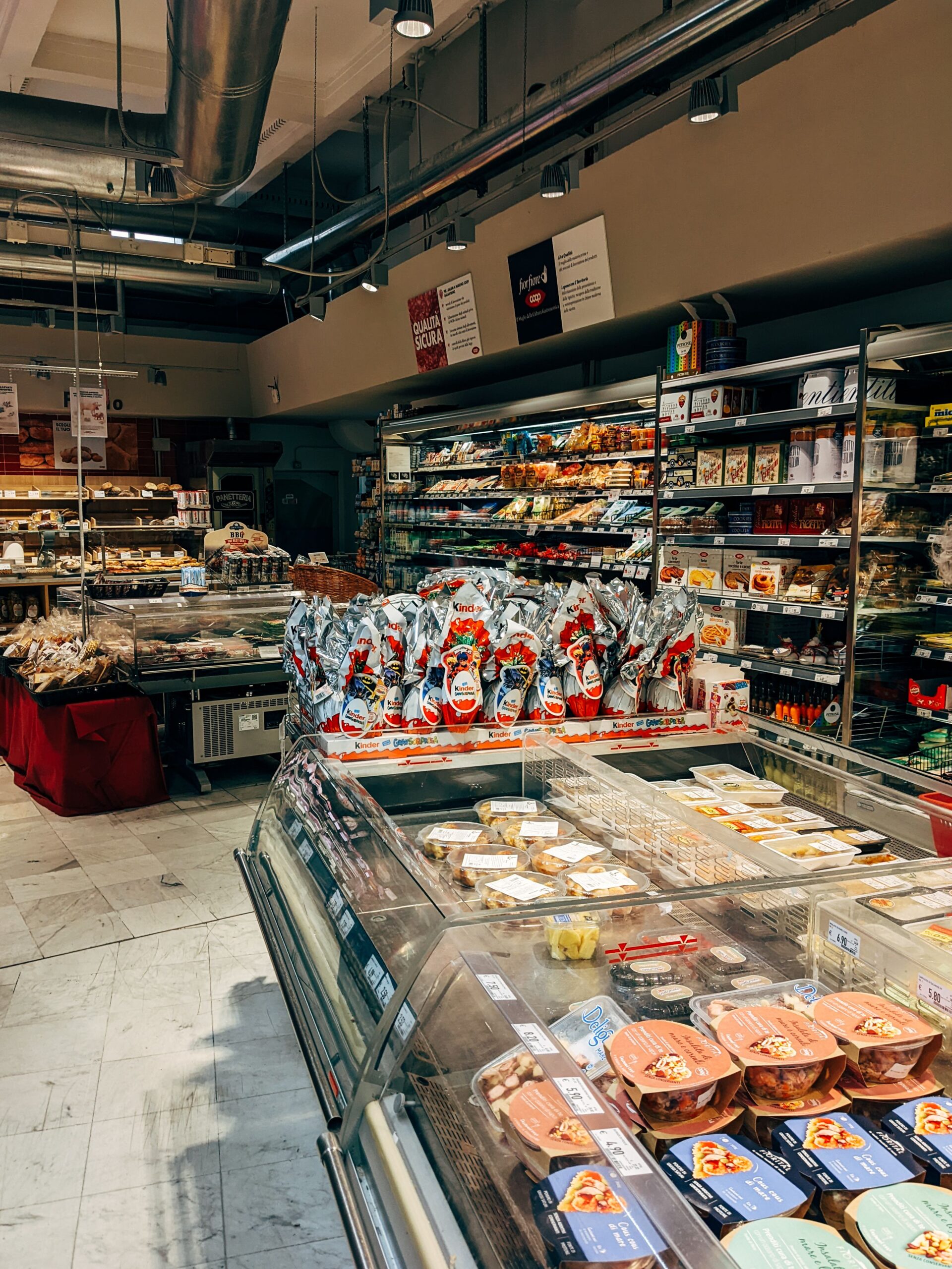 A well-organized supermarket aisle featuring diverse food items and grocery products.