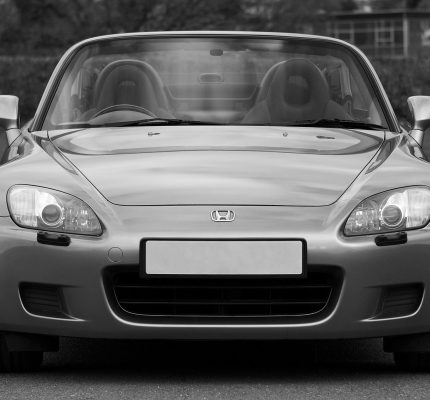 Front view of a parked monochrome Honda convertible car outdoors in the UK.