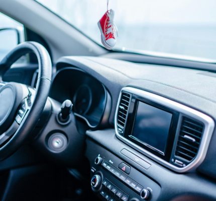 Close-up view of a modern car interior focusing on the steering wheel and dashboard.